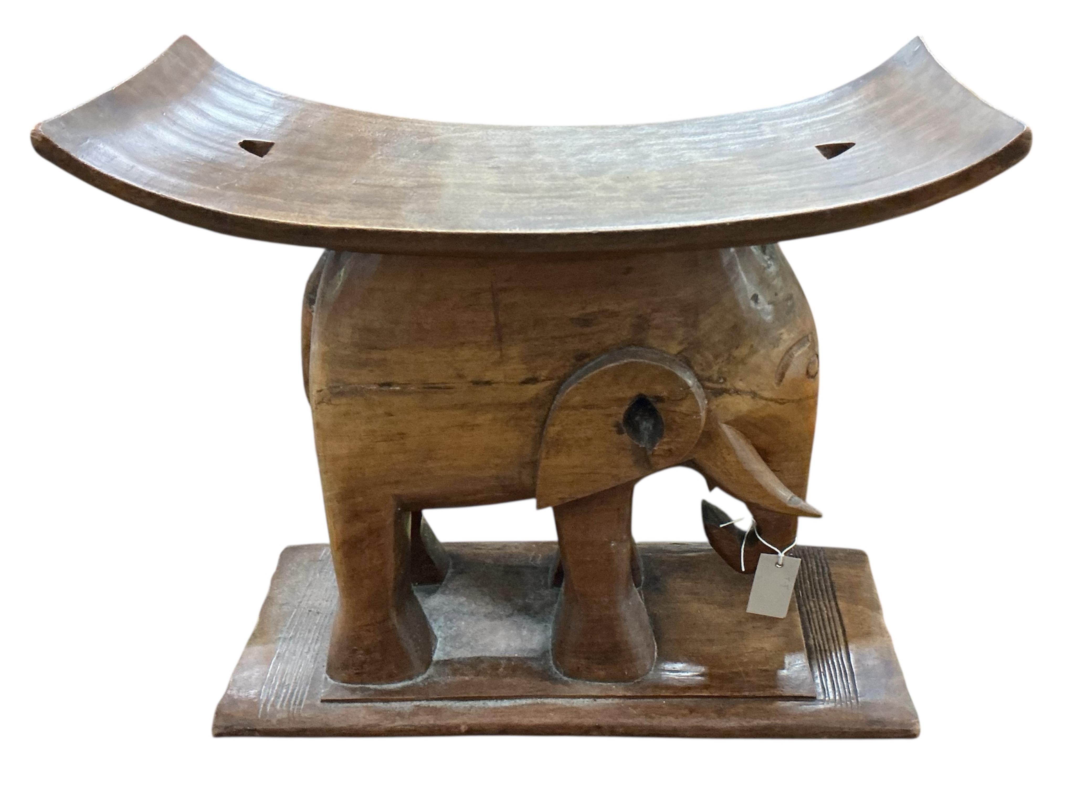 An African elephant carved Ashanti style stool, width 60cm, depth 30cm, height 51cm
